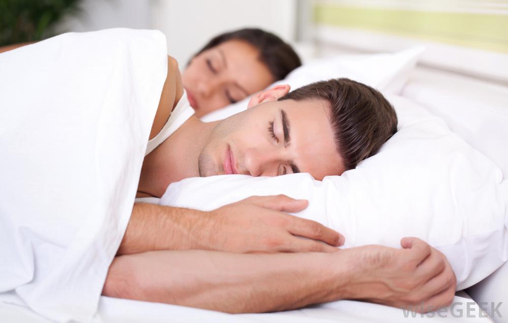 man-and-woman-sleeping-white-bed